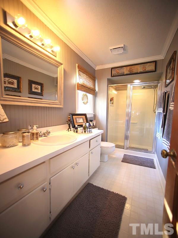 6216 Wynbrook Way Raleigh, NC 27612 - Photo 12 of 19 a spacious bathroom with a double vanity sink toilet next to a window