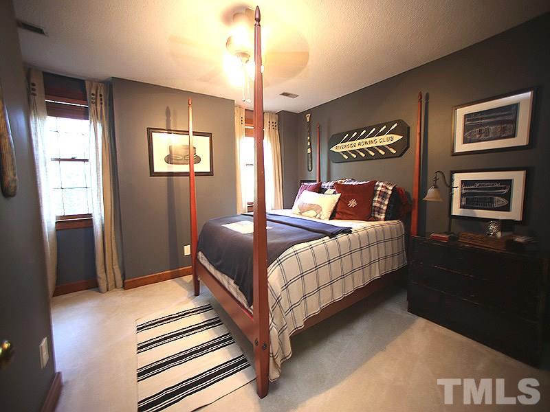 6216 Wynbrook Way Raleigh, NC 27612 - Photo 13 of 19 a bedroom with a bed and a chandelier