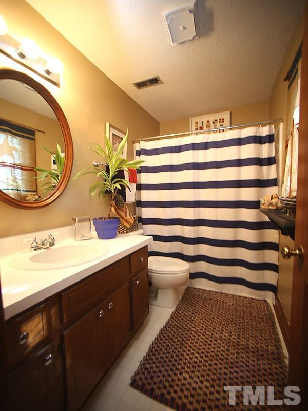 6216 Wynbrook Way Raleigh, NC 27612 - Photo 15 of 19 a bathroom with a sink and a mirror