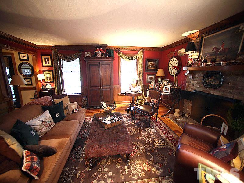 6216 Wynbrook Way Raleigh, NC 27612 - Photo 5 of 19 a living room with furniture a lamp and a fireplace