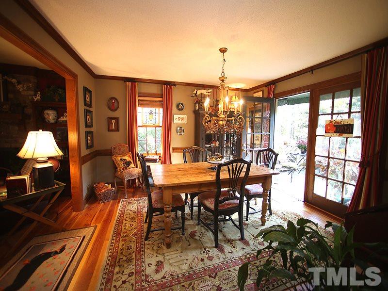 6216 Wynbrook Way Raleigh, NC 27612 - Photo 6 of 19 a dining room with furniture a chandelier and wooden floor