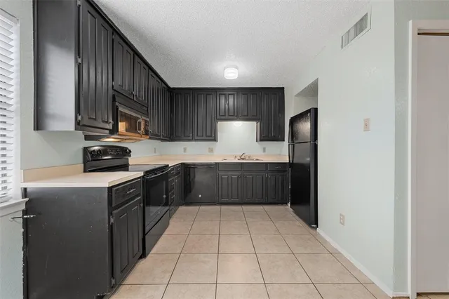 a kitchen with a sink a counter top space and cabinets