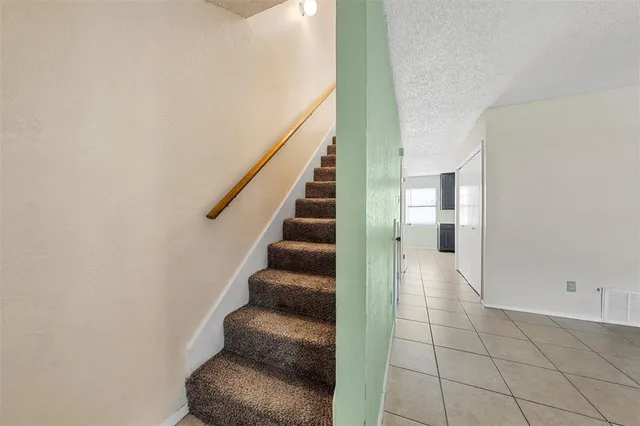 a view of a hallway with wooden floor and entryway