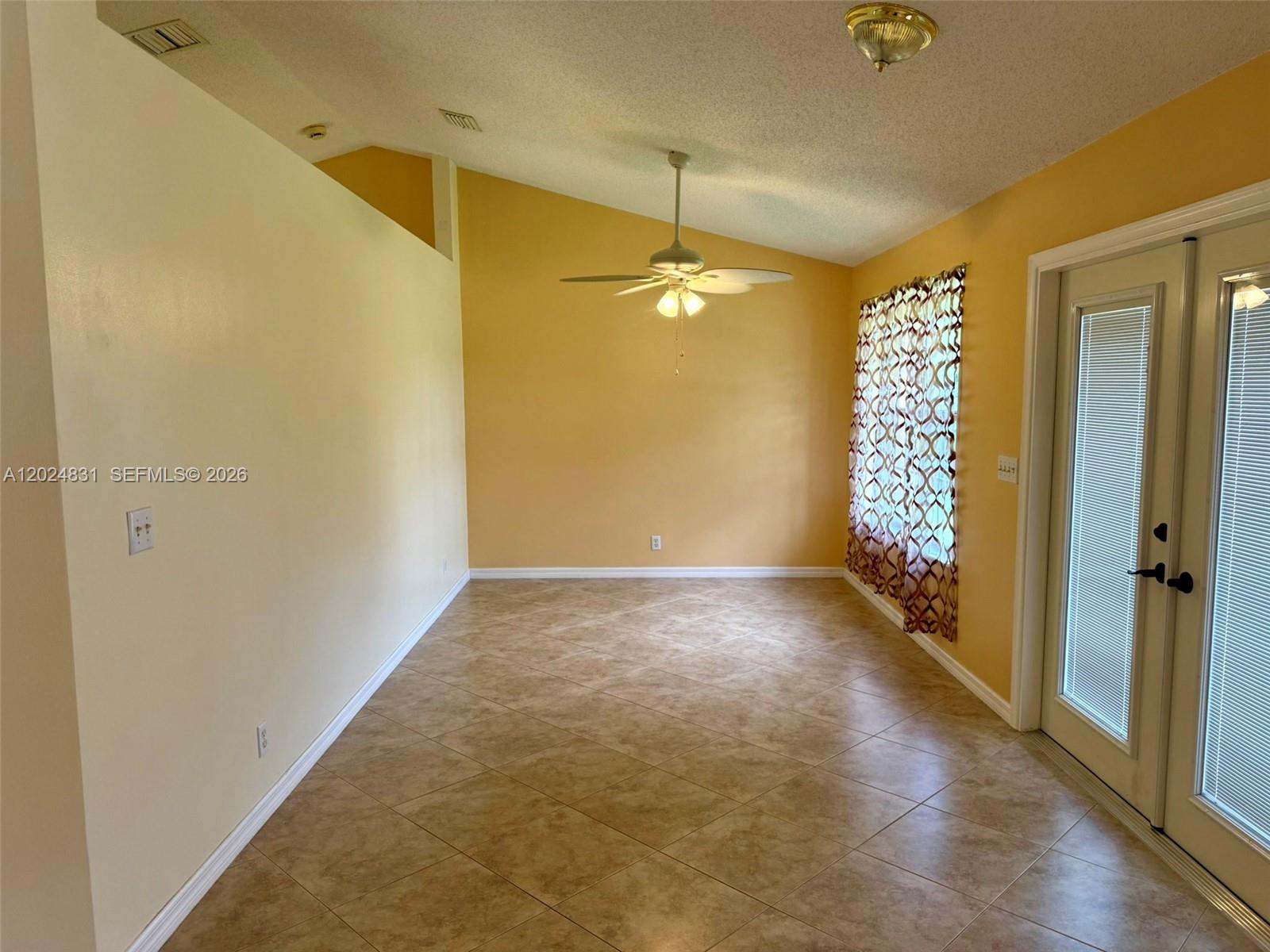 15819 76th Road North Loxahatchee, FL 33470 - Photo 8 of 45 an empty room with windows and chandelier fan