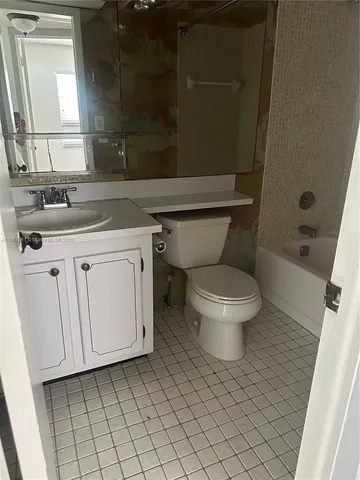 a white toilet sitting next to a bathroom sink