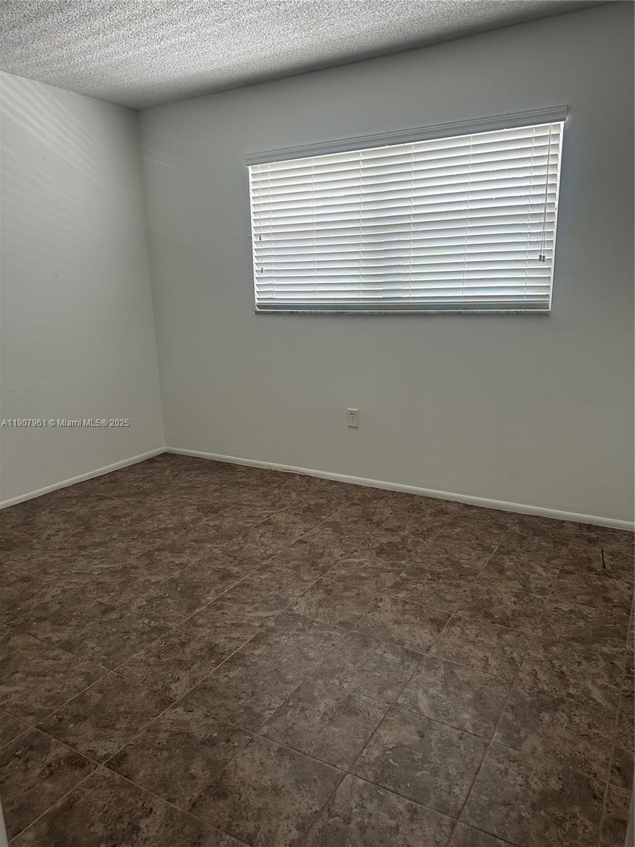 8110 Sunrise Lakes Boulevard, Unit 304 Sunrise, FL 33322 - Photo 6 of 9 an empty room with a window