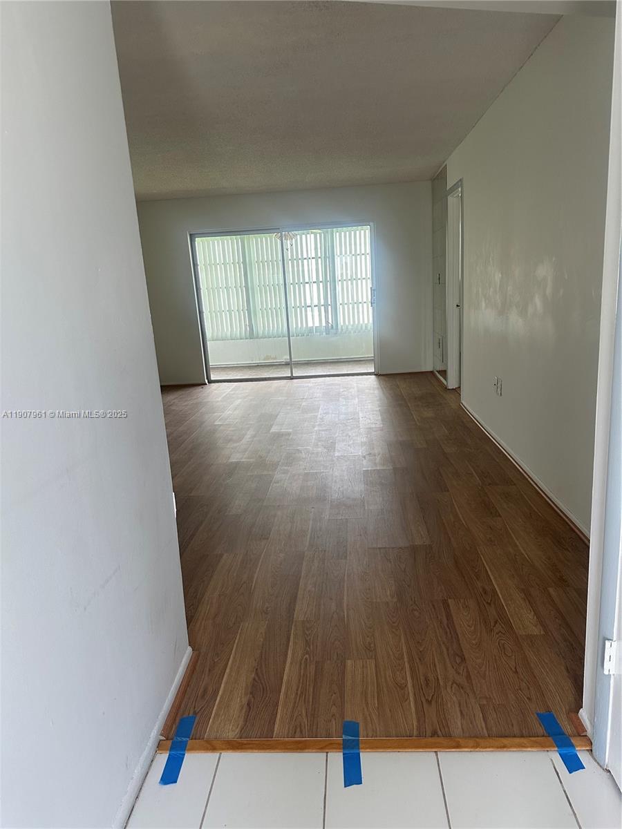 8110 Sunrise Lakes Boulevard, Unit 304 Sunrise, FL 33322 - Photo 7 of 9 a view of an empty room with wooden floor and fan