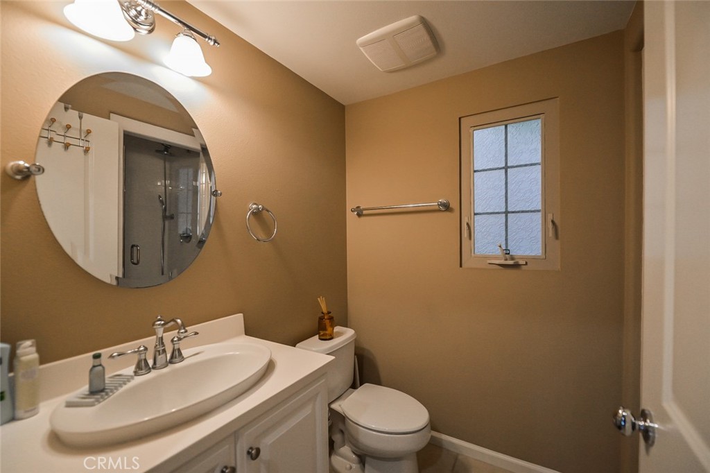 64 Scarlet Bloom Irvine, CA 92618 - Photo 11 of 22 a bathroom with a toilet sink and mirror