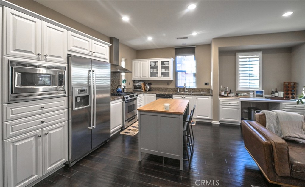 64 Scarlet Bloom Irvine, CA 92618 - Photo 16 of 22 a kitchen with counter top space cabinets and stainless steel appliances