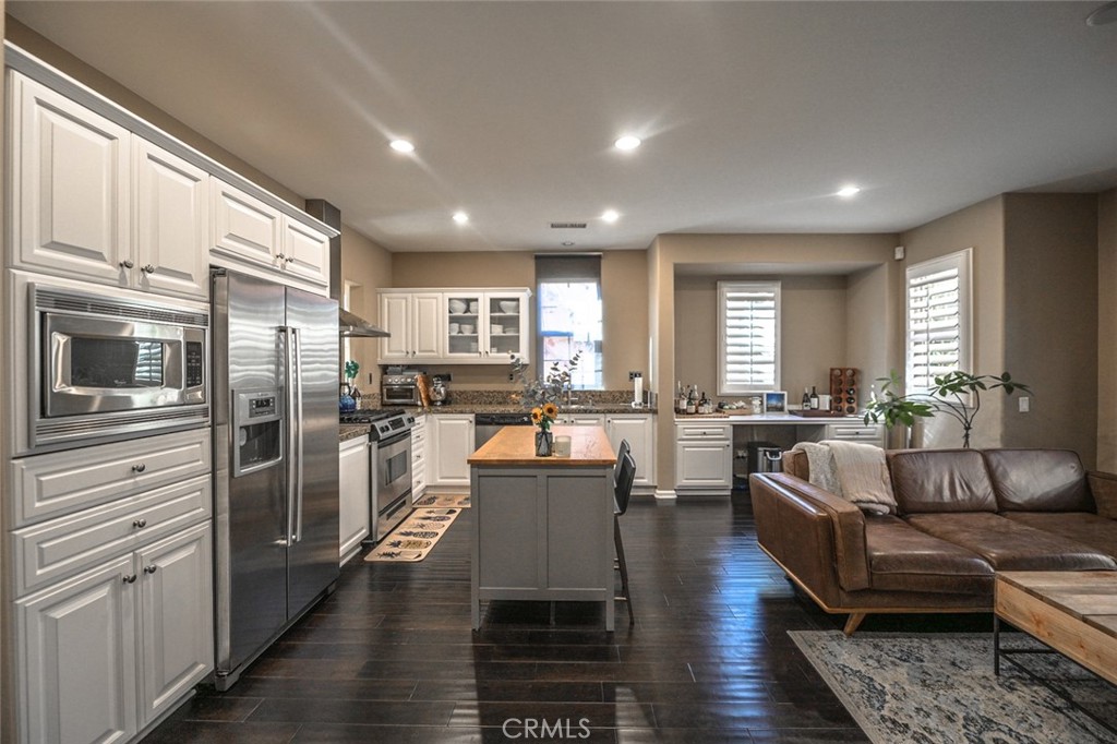 64 Scarlet Bloom Irvine, CA 92618 - Photo 17 of 22 a living room with stainless steel appliances furniture refrigerator and kitchen view