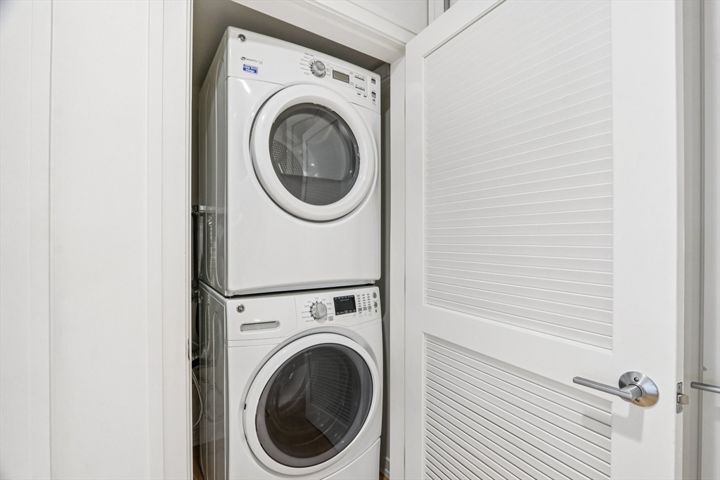 77 New Street, Unit 317 Cambridge, MA 02138 - Photo 11 of 12 a view of a hallway with washer and dryer
