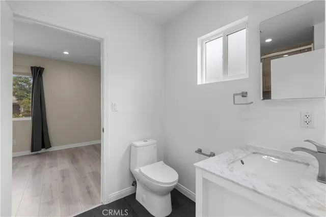 a bathroom with a sink toilet and vanity