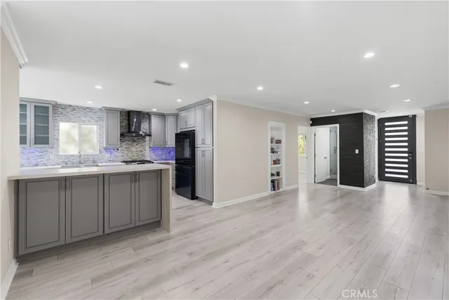 a open kitchen with stainless steel appliances granite countertop a refrigerator and a sink