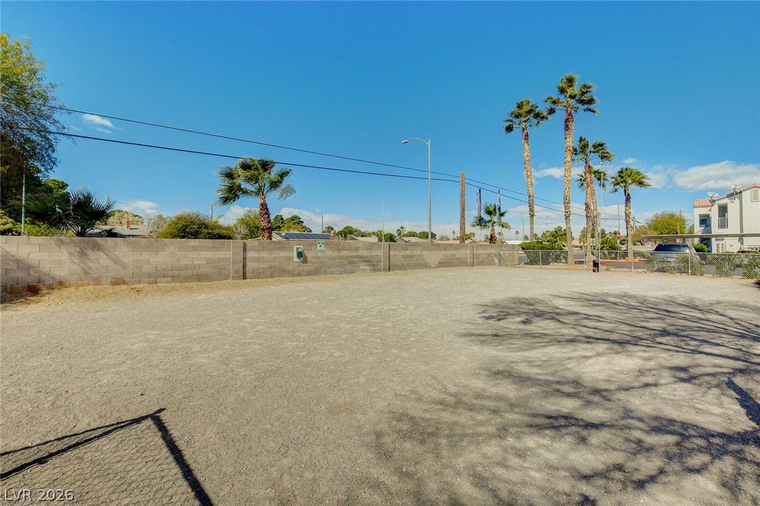 3318 North Decatur Boulevard, Unit 2072 Las Vegas, NV 89130 - Photo 44 of 50 A spacious lot with a block wall and mature palm trees offers potential for outdoor enjoyment.