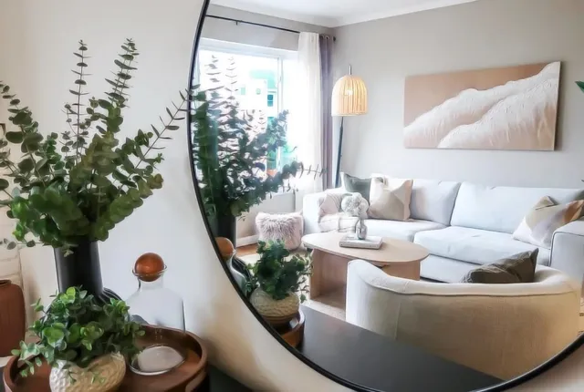 a living room with furniture and a potted plant