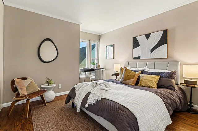 a bedroom with a bed a couch and a window