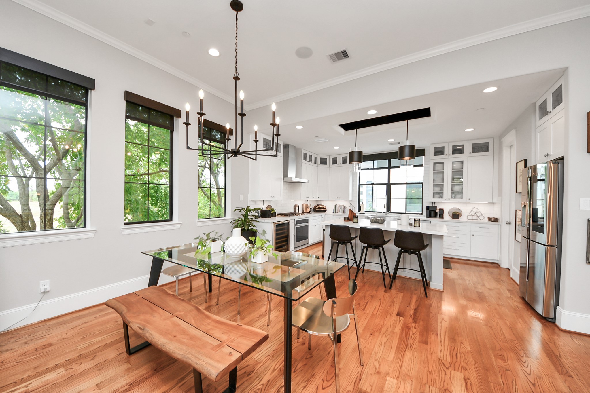 2765 Freund Street Houston, TX 77003 - Photo 11 of 44 Experience serene views through windows adorned with electronic shades, inviting filtered light and lush greenery inside.