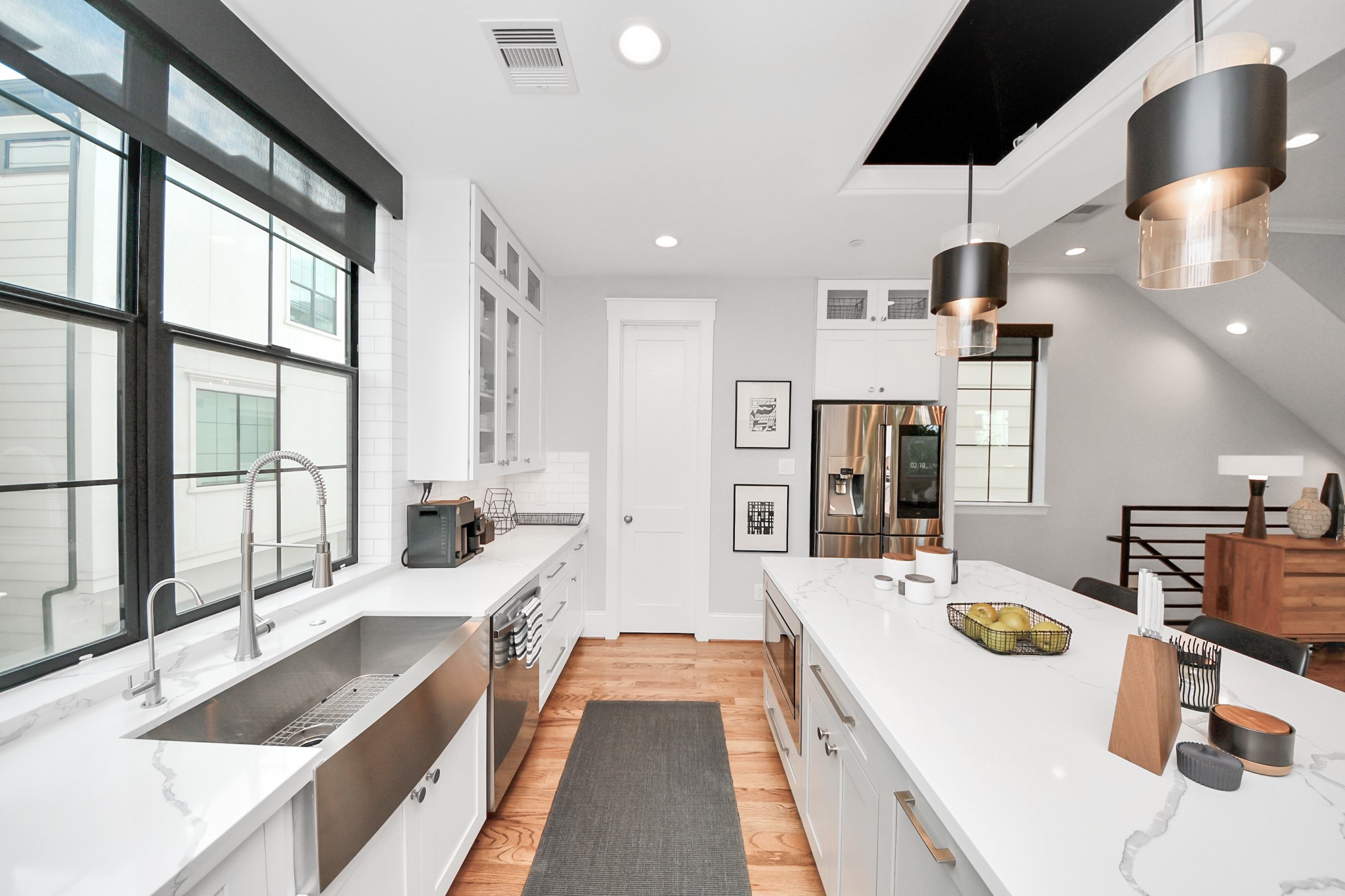 2765 Freund Street Houston, TX 77003 - Photo 16 of 44 a large kitchen with kitchen island a large counter space and a view of living room