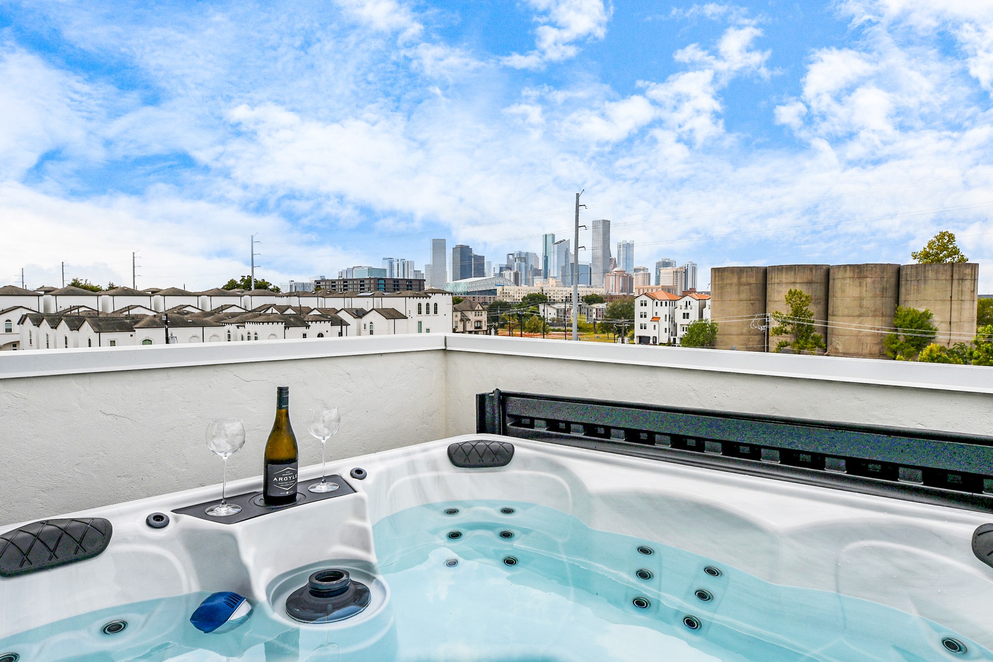 2765 Freund Street Houston, TX 77003 - Photo 4 of 44 Rooftop terrace with a hot tub offers stunning city skyline views, perfect for relaxing and entertaining.