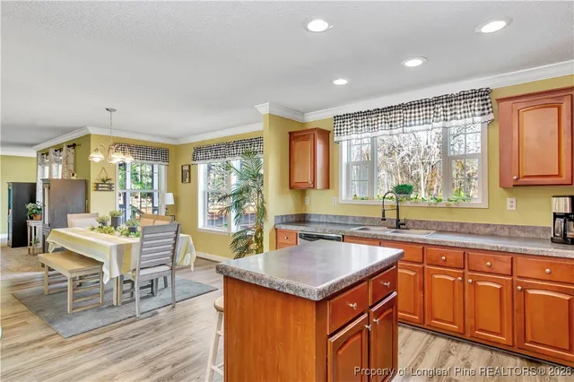 a kitchen with a stove a sink a counter space and dining table