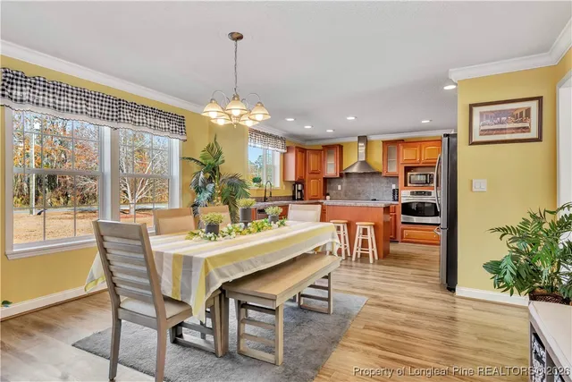 a dining room filled with lots of furniture and a chandelier