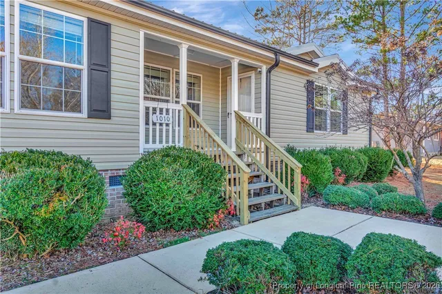 a view of a house with brick walls and flower plants