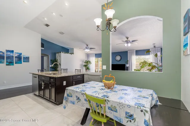 a view of a dining room with furniture and chandelier