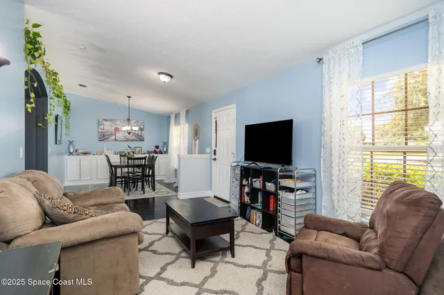 a living room with furniture and a flat screen tv