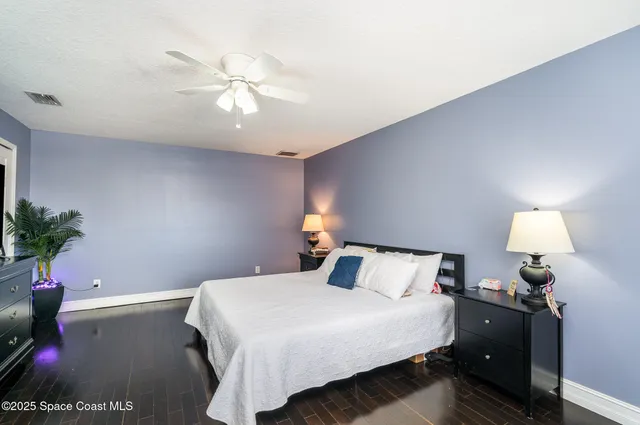 a bedroom with a bed and a potted plant