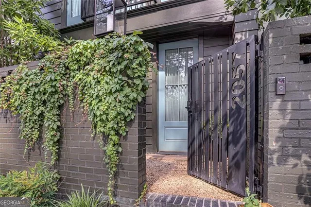 a couple of potted plants in front of door