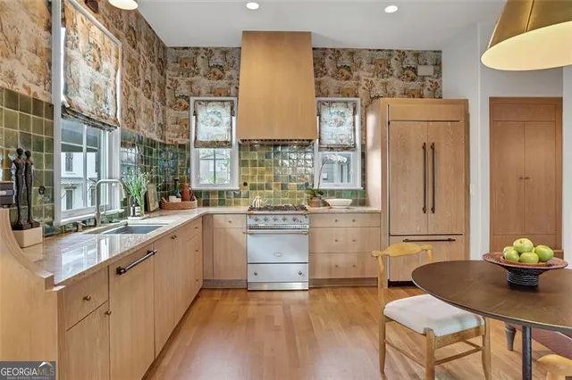 a stove top oven sitting inside of a kitchen