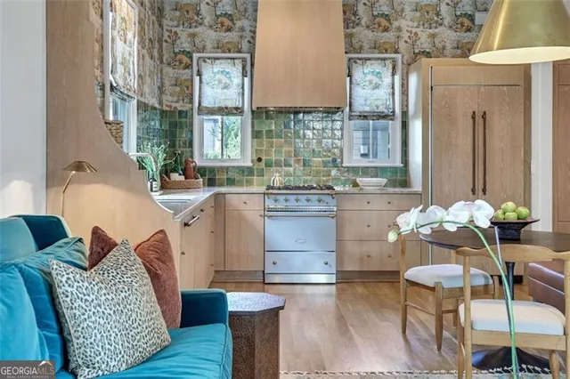 a living room with furniture a fireplace and a chandelier