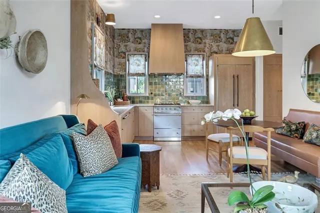 a living room with furniture a table and a chandelier