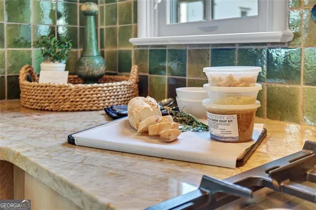 a kitchen with granite countertop a stove and a white refrigerator