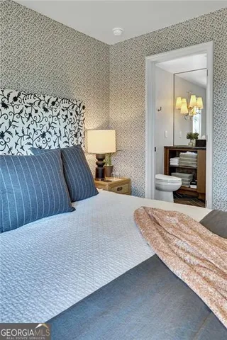 a bedroom with a bed and a mirror