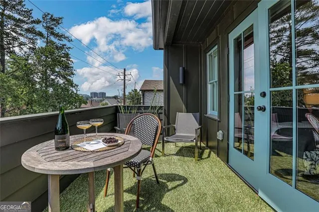 a balcony with table and chairs