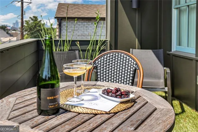 a view of a house with backyard and sitting area