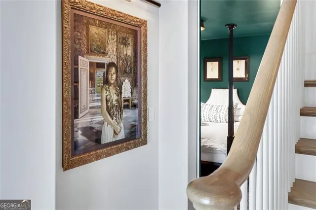 a bedroom with a bed lamps and a large mirror