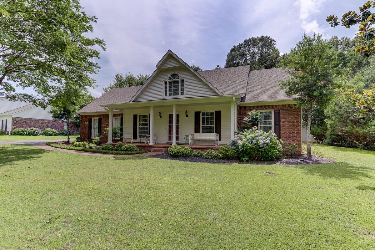 a front view of a house with swimming pool having outdoor seating