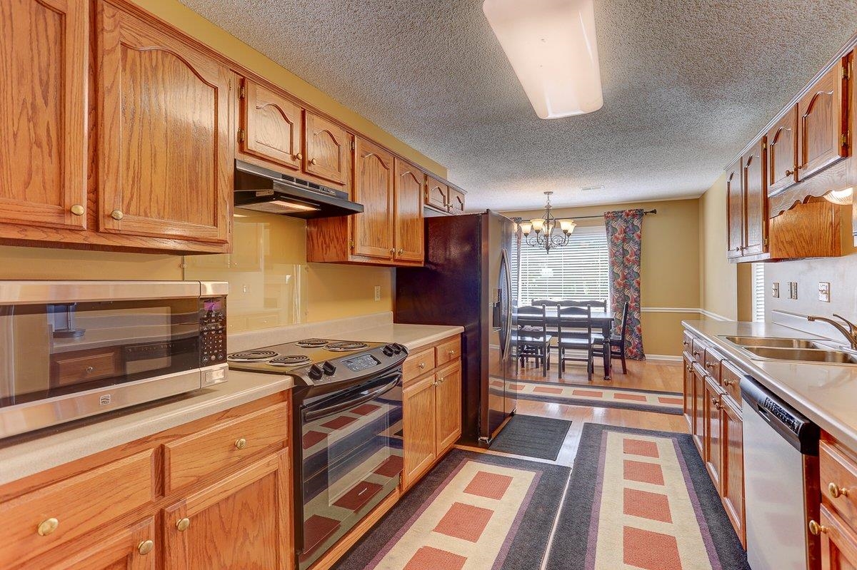 3365 Harrell Road Arlington, TN 38002 - Photo 12 of 36 a kitchen with stainless steel appliances granite countertop a stove a sink and a microwave