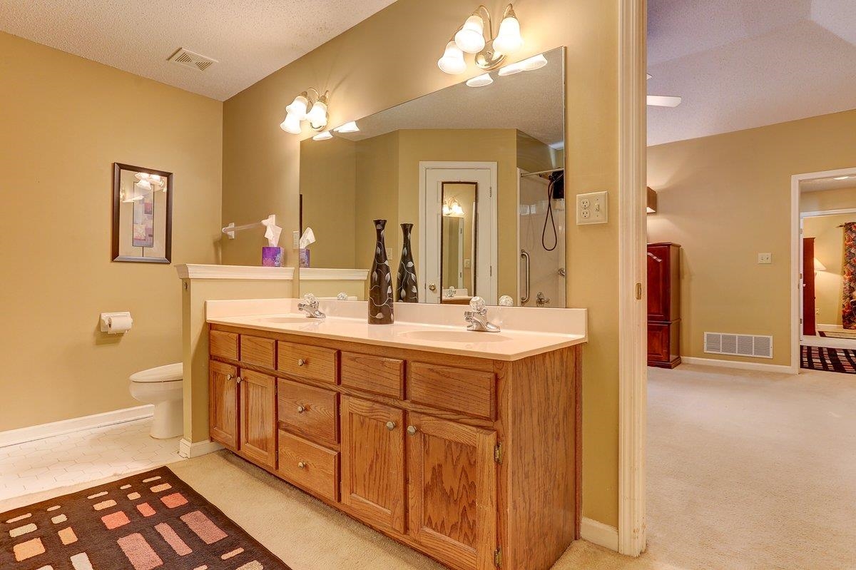 3365 Harrell Road Arlington, TN 38002 - Photo 21 of 36 a spacious bathroom with a double vanity sink and a mirror