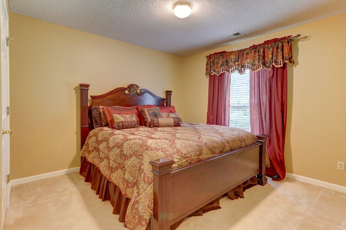 3365 Harrell Road Arlington, TN 38002 - Photo 24 of 36 a bed sitting in a bedroom next to a window