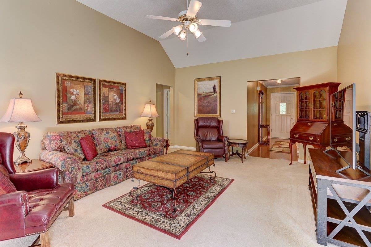 3365 Harrell Road Arlington, TN 38002 - Photo 8 of 36 a living room with furniture a rug and a chandelier