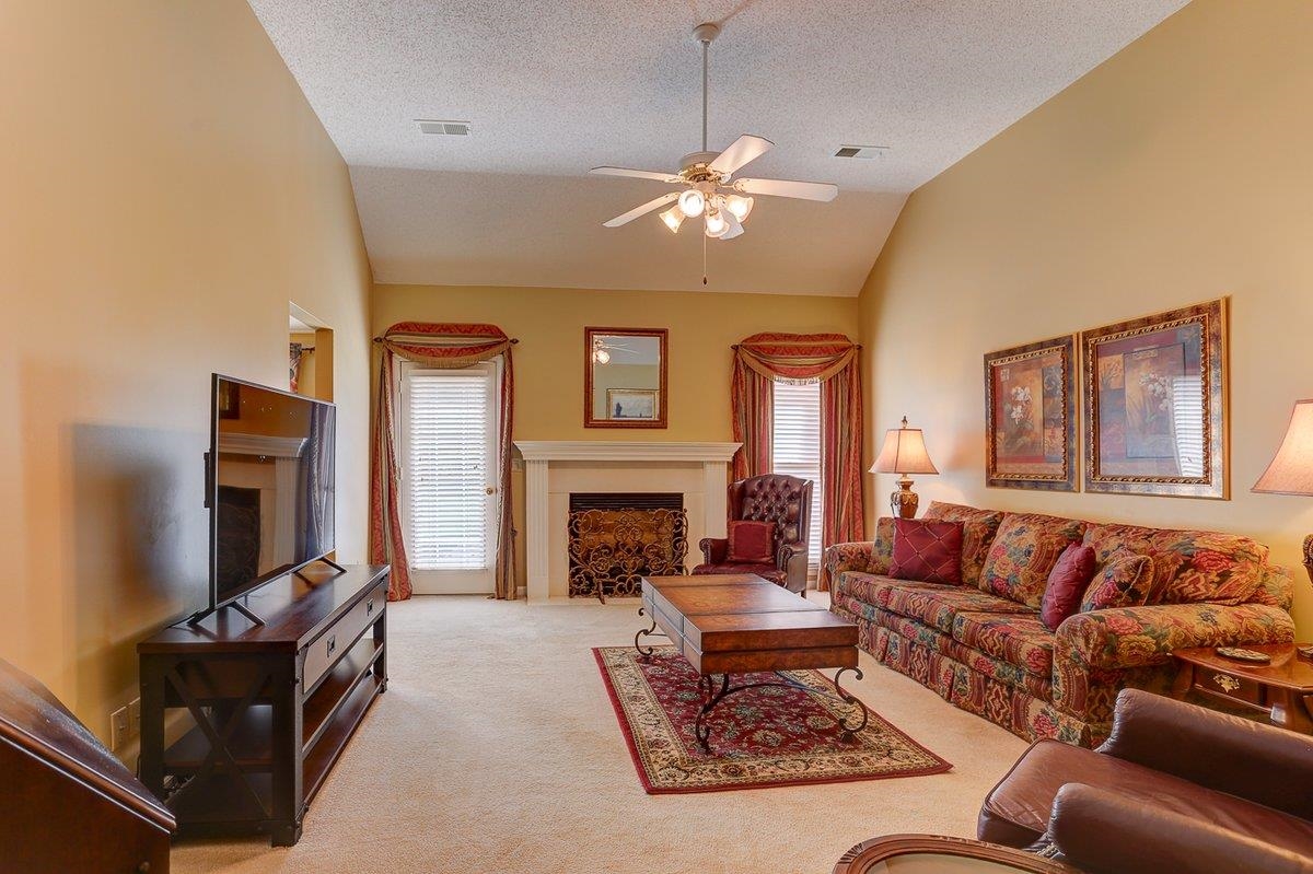 3365 Harrell Road Arlington, TN 38002 - Photo 10 of 36 a living room with furniture a fireplace and a chandelier