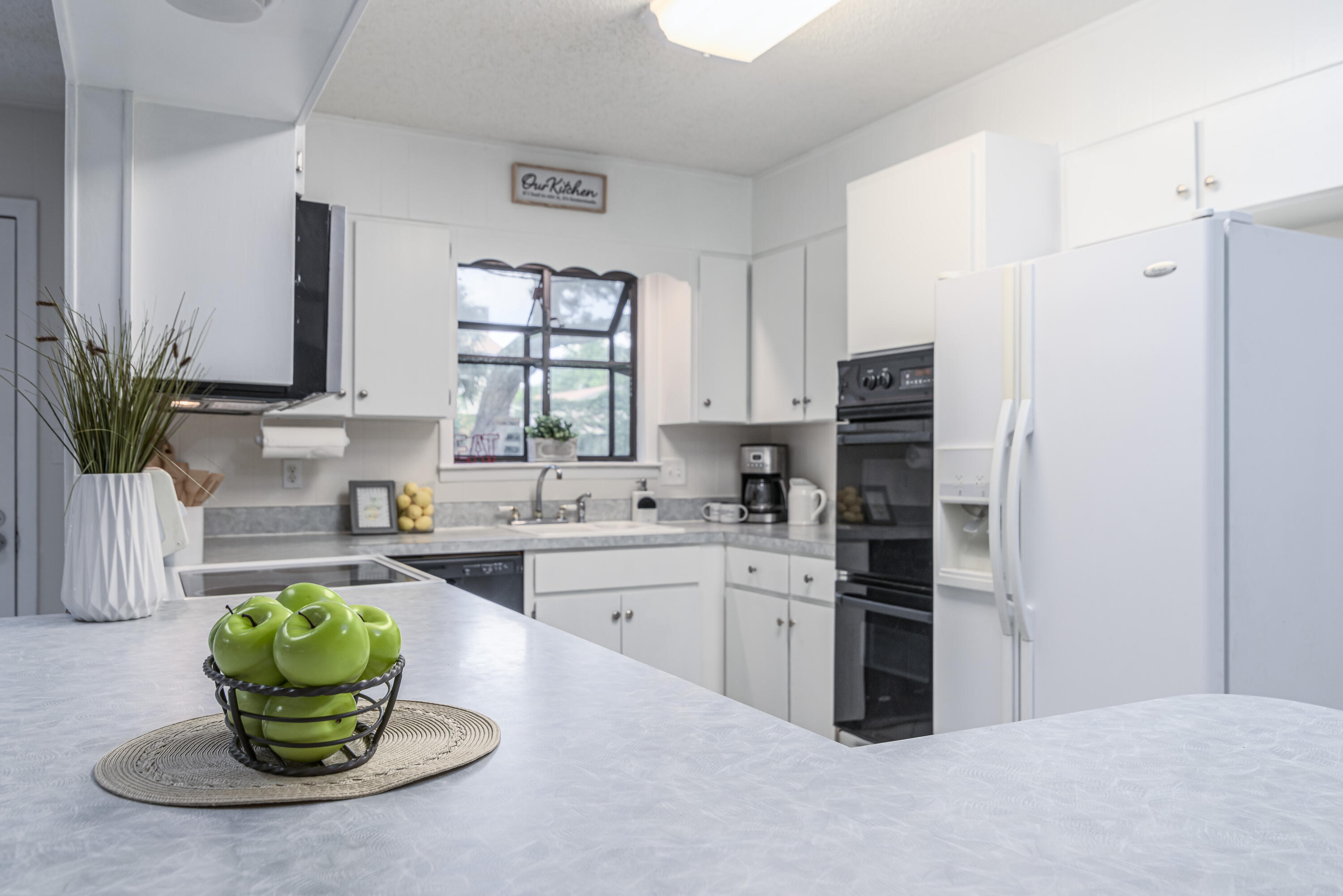 207 Country Club Road Shalimar, FL 32579 - Photo 16 of 60 a kitchen with a refrigerator and a sink