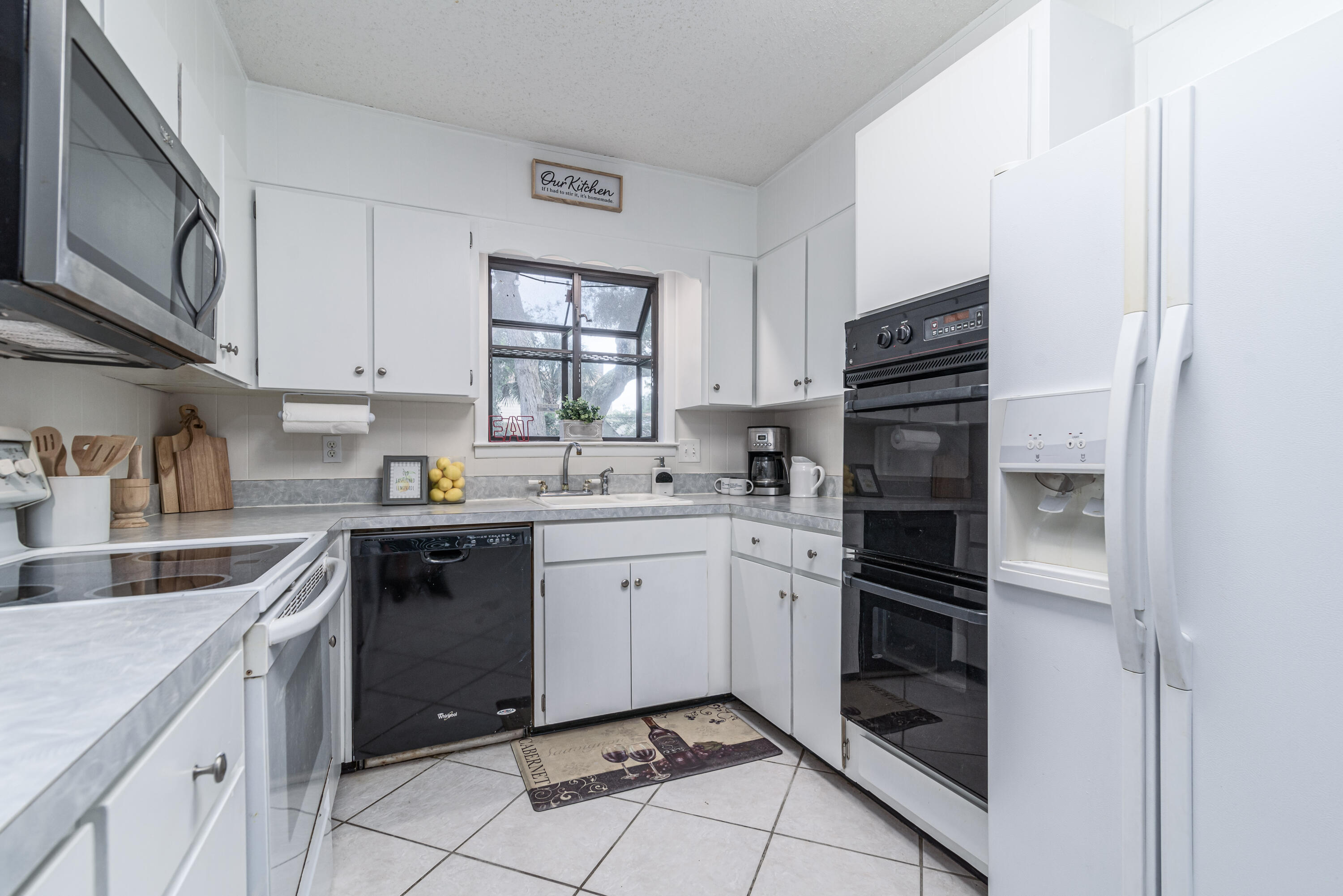 207 Country Club Road Shalimar, FL 32579 - Photo 19 of 60 a kitchen with a refrigerator sink and cabinets