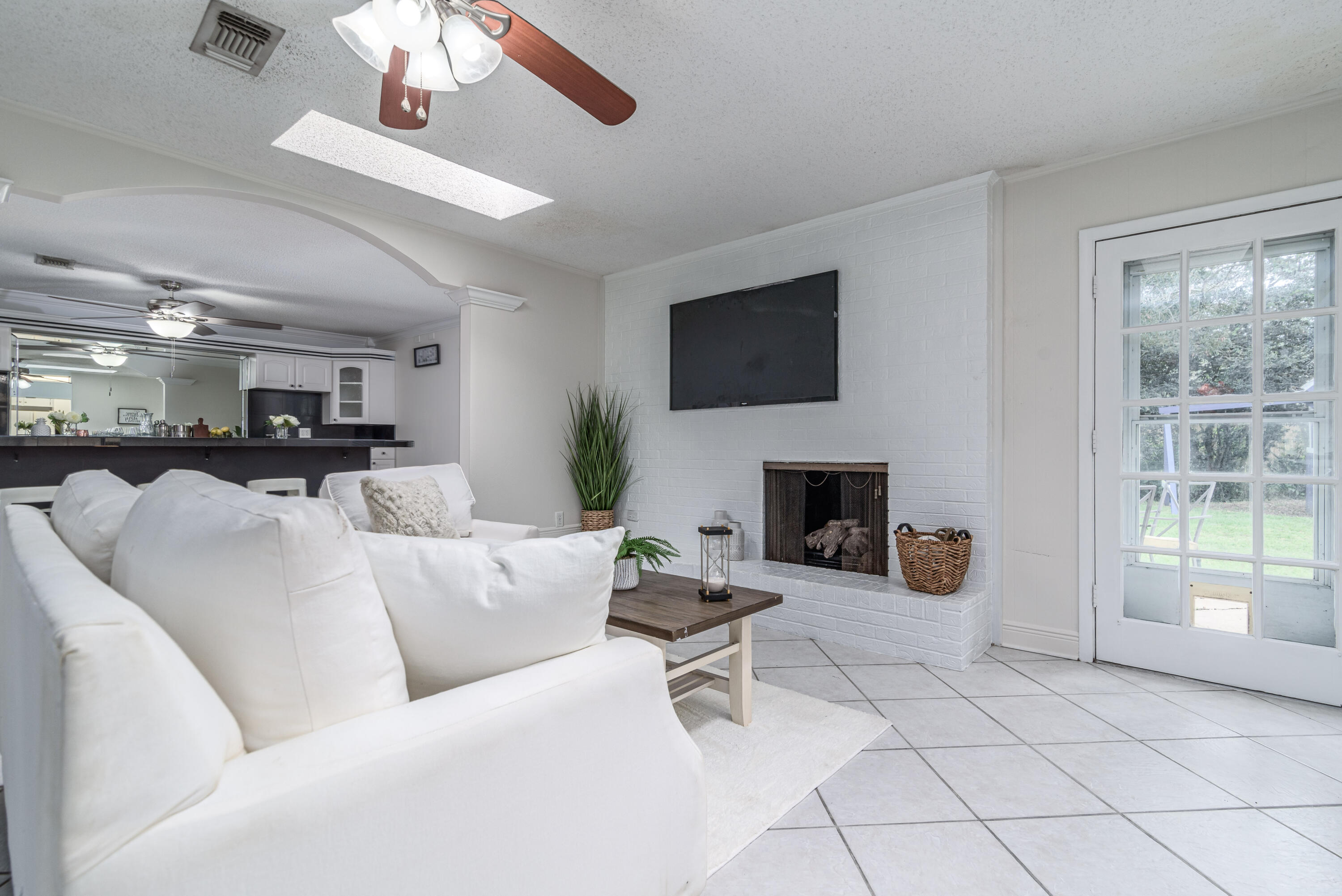 207 Country Club Road Shalimar, FL 32579 - Photo 22 of 60 a living room with furniture a fireplace and a flat screen tv