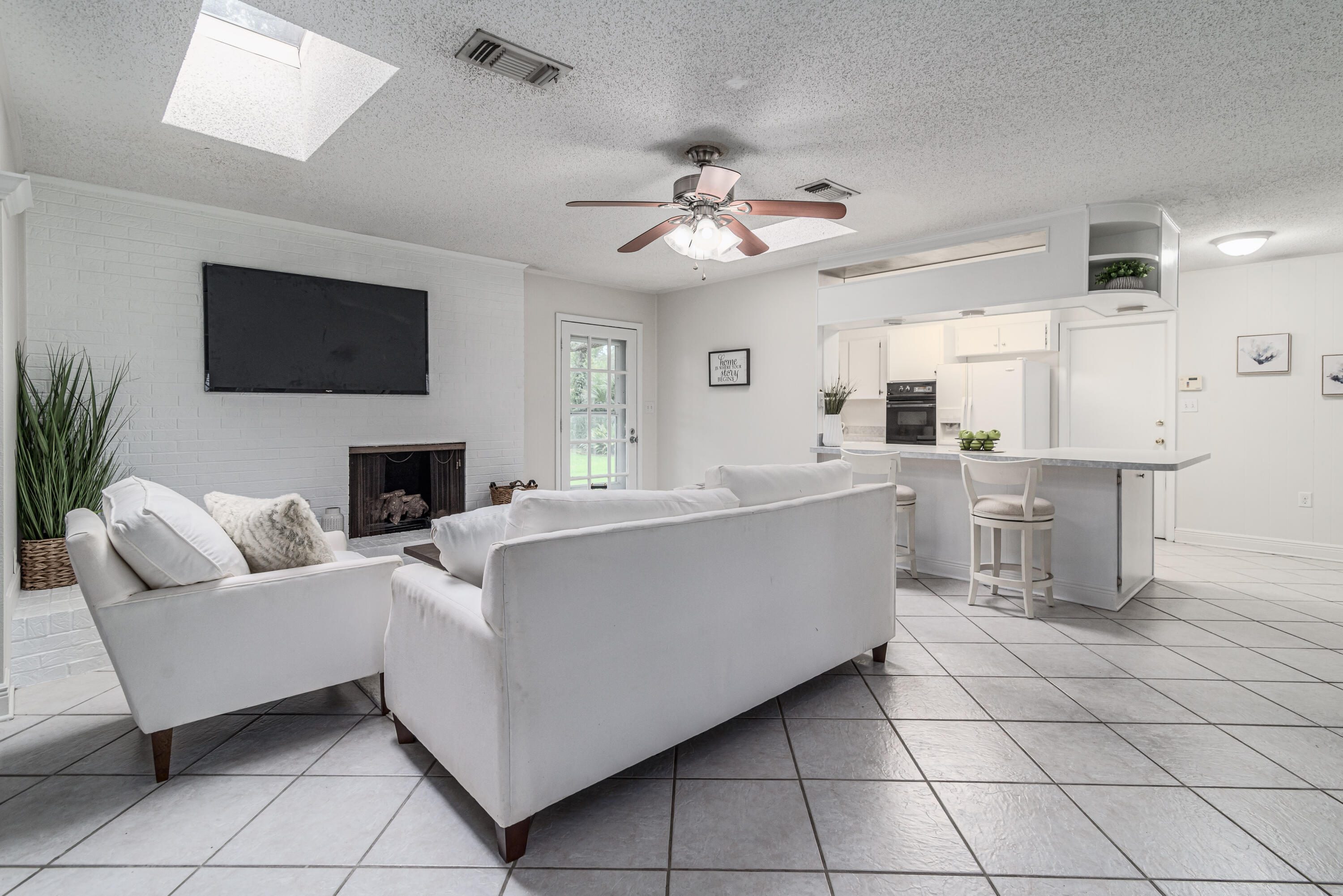 207 Country Club Road Shalimar, FL 32579 - Photo 29 of 60 a living room with furniture a fireplace and a flat screen tv
