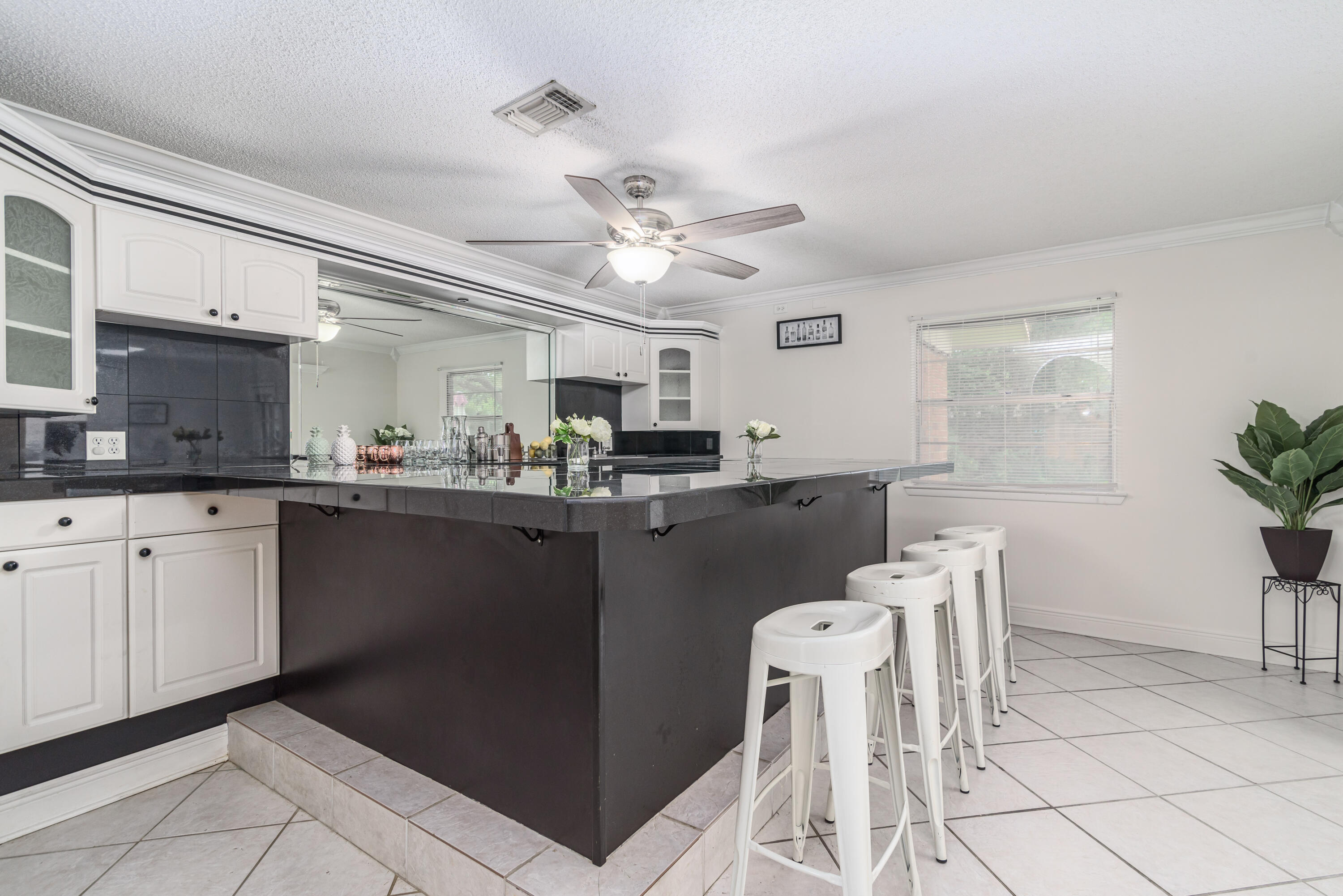 207 Country Club Road Shalimar, FL 32579 - Photo 30 of 60 a kitchen with stainless steel appliances granite countertop a refrigerator a sink dishwasher a dining table and chairs with wooden floor