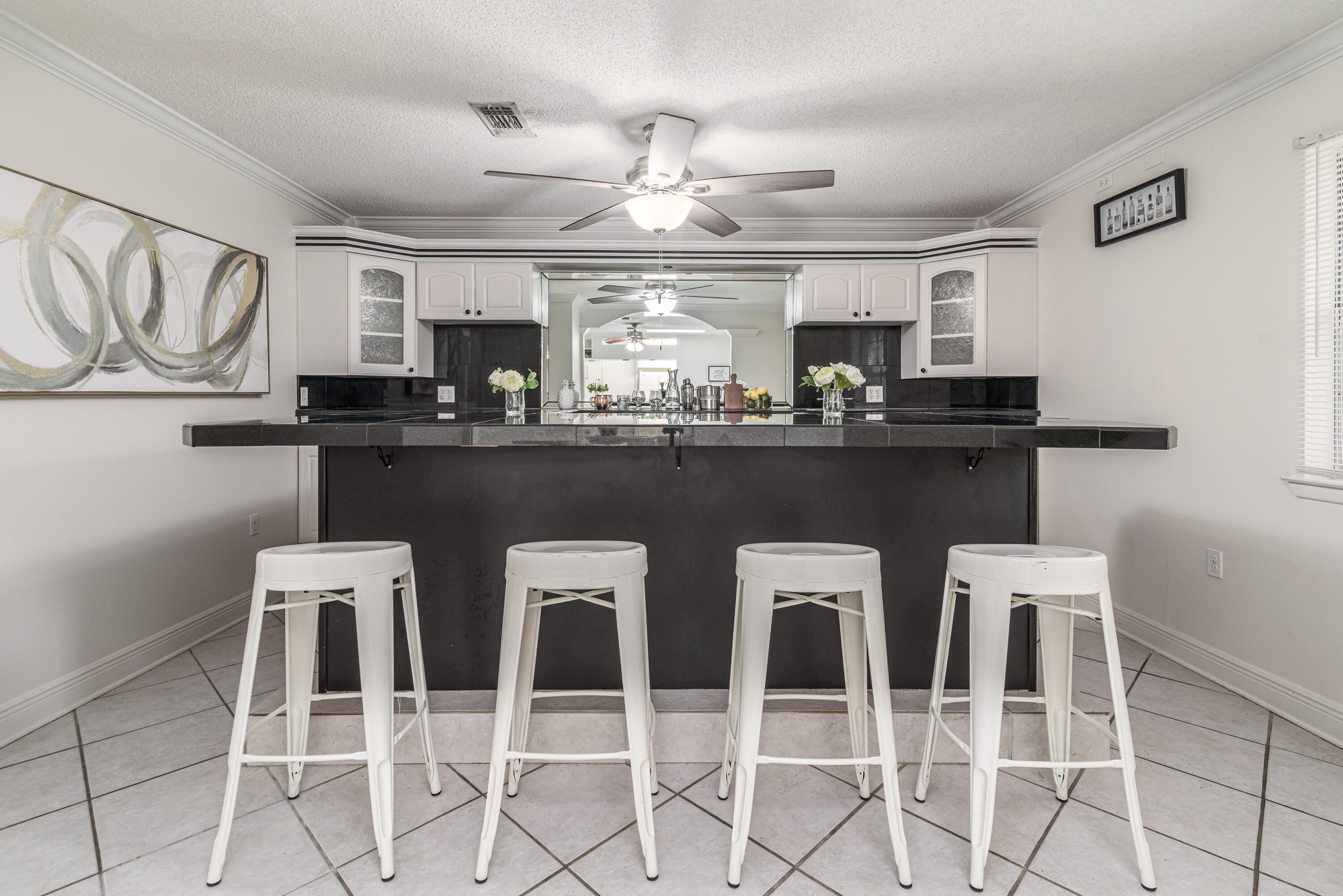 207 Country Club Road Shalimar, FL 32579 - Photo 31 of 60 a kitchen with a dining table chairs cabinets and stainless steel appliances